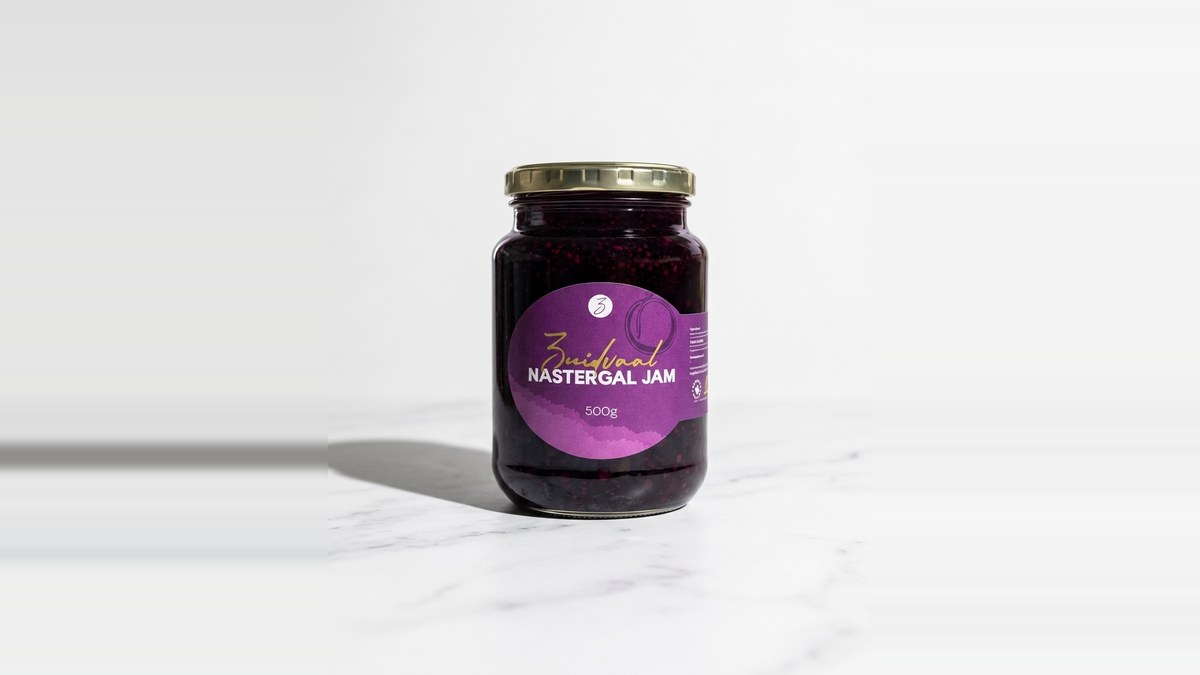 A 500g jar of Zuidvaal Nastergal Jam on white marble — the deep purple-black preserve, available to buy online direct from the farm
